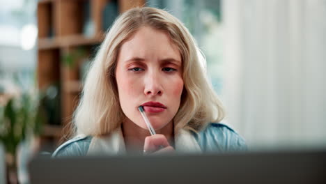a woman thinking in front of a laptop
