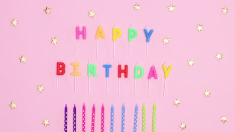 happy birthday stop motion. colorful candles and candles with happy birthday text appear on pastel pink theme