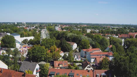 ferris wheel - fair in a small german town between houses and trees