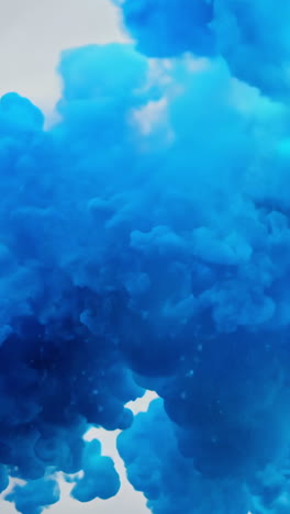 blue smoke cloud during daytime outdoor event. a vibrant blue smoke cloud rises into the sky, creating a striking visual effect during an outdoor activity. vertical video