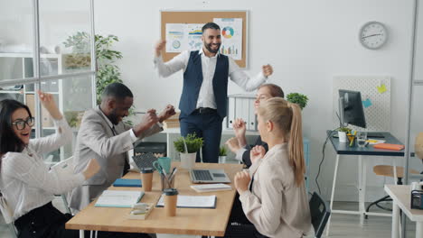 Happy Team Celebrating Success in Office