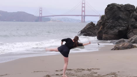 woman draws a line in the sand, metaphorically and literally, dancing on the beach