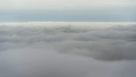 Timelapse-mountain-peak-above-the-clouds-blue-horizon-sea-of-clouds