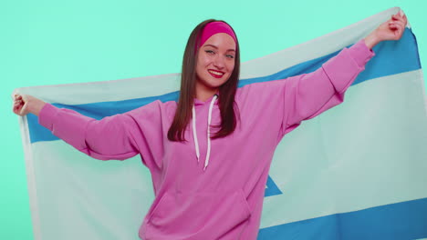 Cheerful-lovely-teen-girl-waving-and-wrapping-in-Israel-national-flag,-celebrating-Independence-day