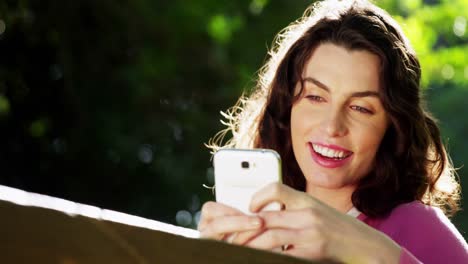 Beautiful-woman-using-mobile-phone-in-park