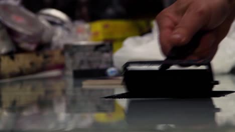 artist spreads ink for a woodblock print.