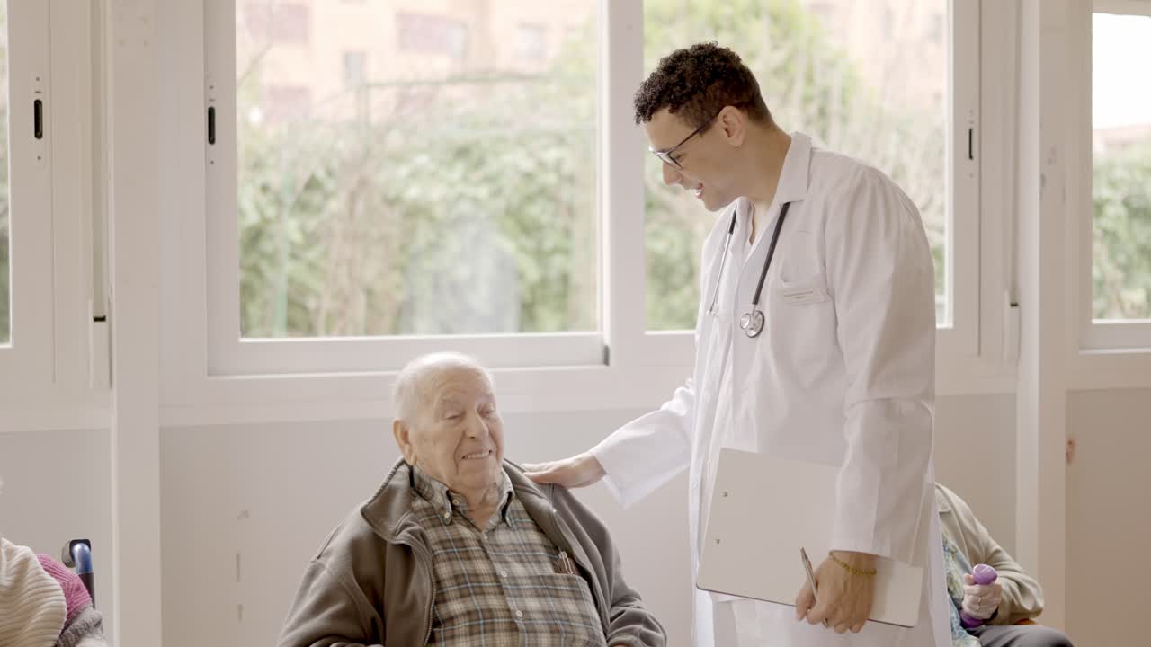 Doctor talking with a senior man in the nursing home
