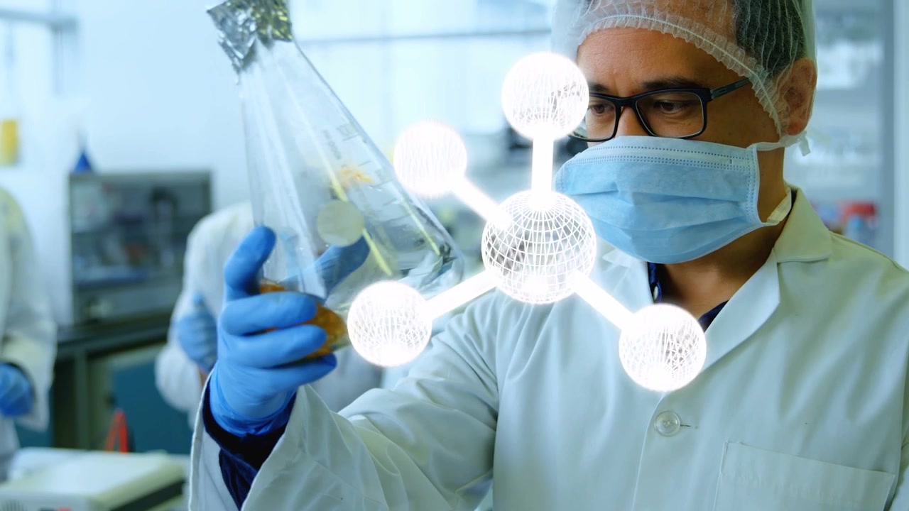 Male lab scientist lifting flask up, rotating it while molecule hologram overlays checking reaction