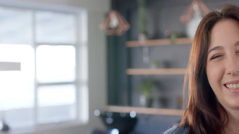 Half-portrait-of-happy-caucasian-female-customer-smiling-at-hair-salon,-copy-space,-in-slow-motion