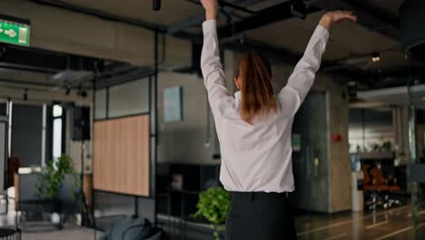 woman celebrating in modern office