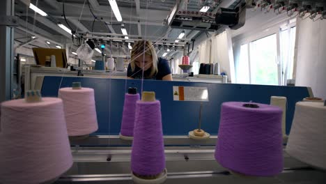 spools of pink thread on knitting machine view