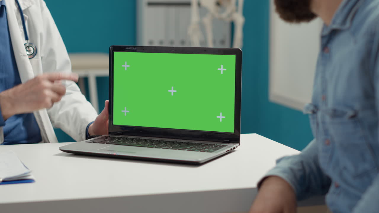 Health physician and sick patient looking at greenscreen