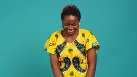 Feminine-natural-young-girl-laughing-at-something-in-studio