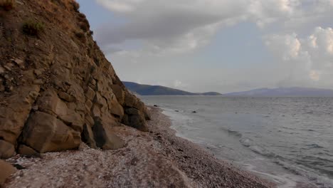 Beautiful-rocky-seaside-with-sea-surrounding-cape-and-cloudy-sky-background-near-Corfu-island