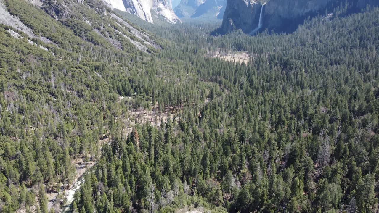 Yosemite Valley (Aerial Flyover) Over Yosemite National Park, California, USA. Camera Tilt Up Towards El Capitan, Half Dome, And Bridal Veil Falls.