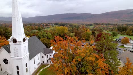 sugar maples aerial near church in manchester vermont in 4k