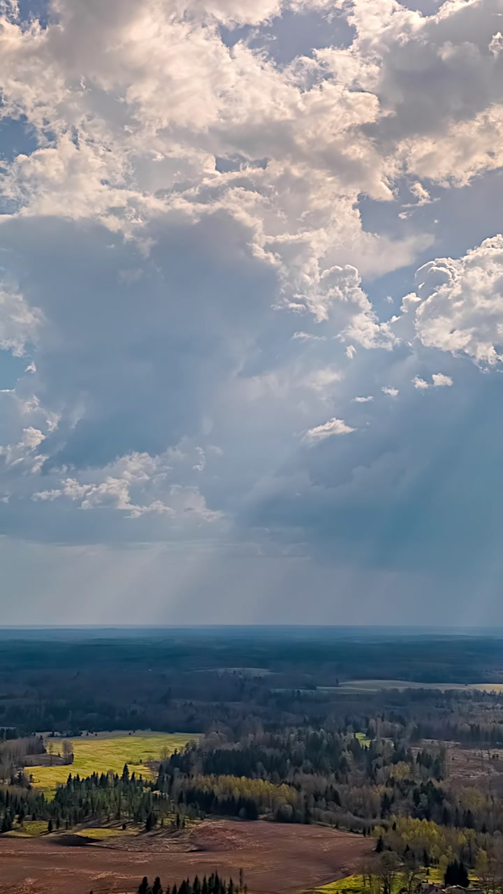 Clouds drift above vast fields in a serene timelapse landscape scene
