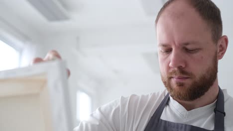 a closeup of an artist paints an abstract picture painting vertical video