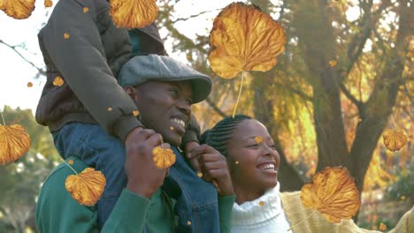 Animation-Von-Herbstblättern-über-Einer-Glücklichen-Afroamerikanischen-Familie-Im-Herbstpark