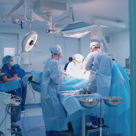 operation room with specialists. teamwork of surgeons performing operation on the background of modern equipment in private clinic.