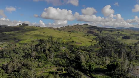 cinematic aerial of green hills and blue sky, papua new guinea highlands landscape