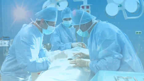 composición digital de puntos de luz contra el equipo de cirujanos que realizan la cirugía en el hospital