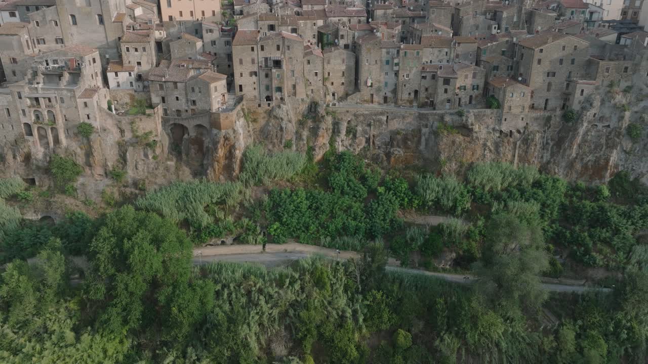 High Angle Aerial Drone view of the hilltop Medieval town of Pitigliano, Tuscany in morning light, with the Valdorcia and old buildings, in 4K