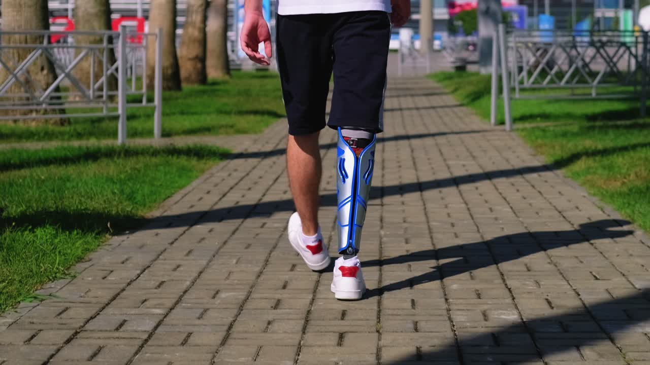 Man with prosthetic leg walking outdoors