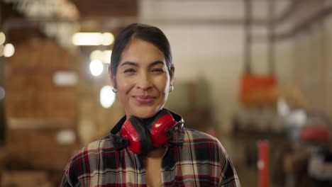 woman carpenter smiling in her workshop