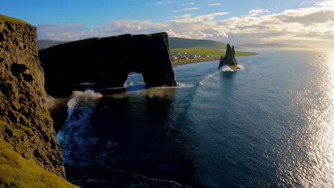 dramatic coastal landscape with sea arch and crashing waves