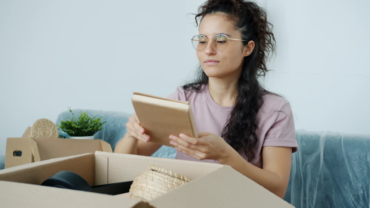 Woman unpacking boxes in her new home