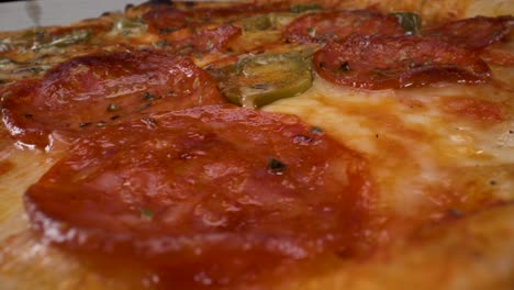 rotating macro close up view of pepperoni jalapeño pizza filmed in 4k with probe lens, fast food, greasy