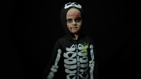 boy dressed up as a skeleton for halloween