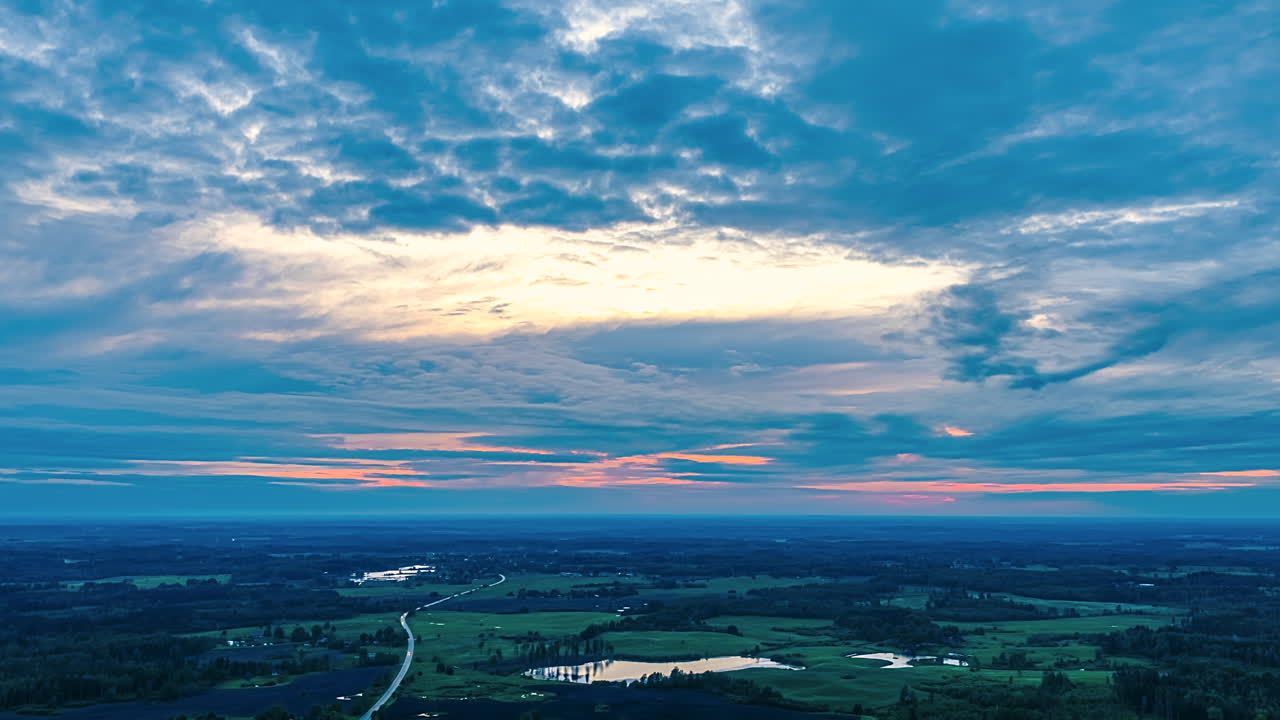 Dense Clouds Rolling During Sunset Over Countryside Landscape. Timelapse