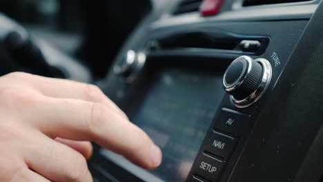 Male-Hand-Adjusts-The-Tuning-Of-The-Car-Radio-Close-Up-Shot