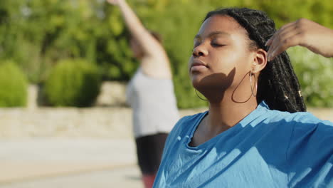 medium shot of woman stretching neck muscle with closed eyes