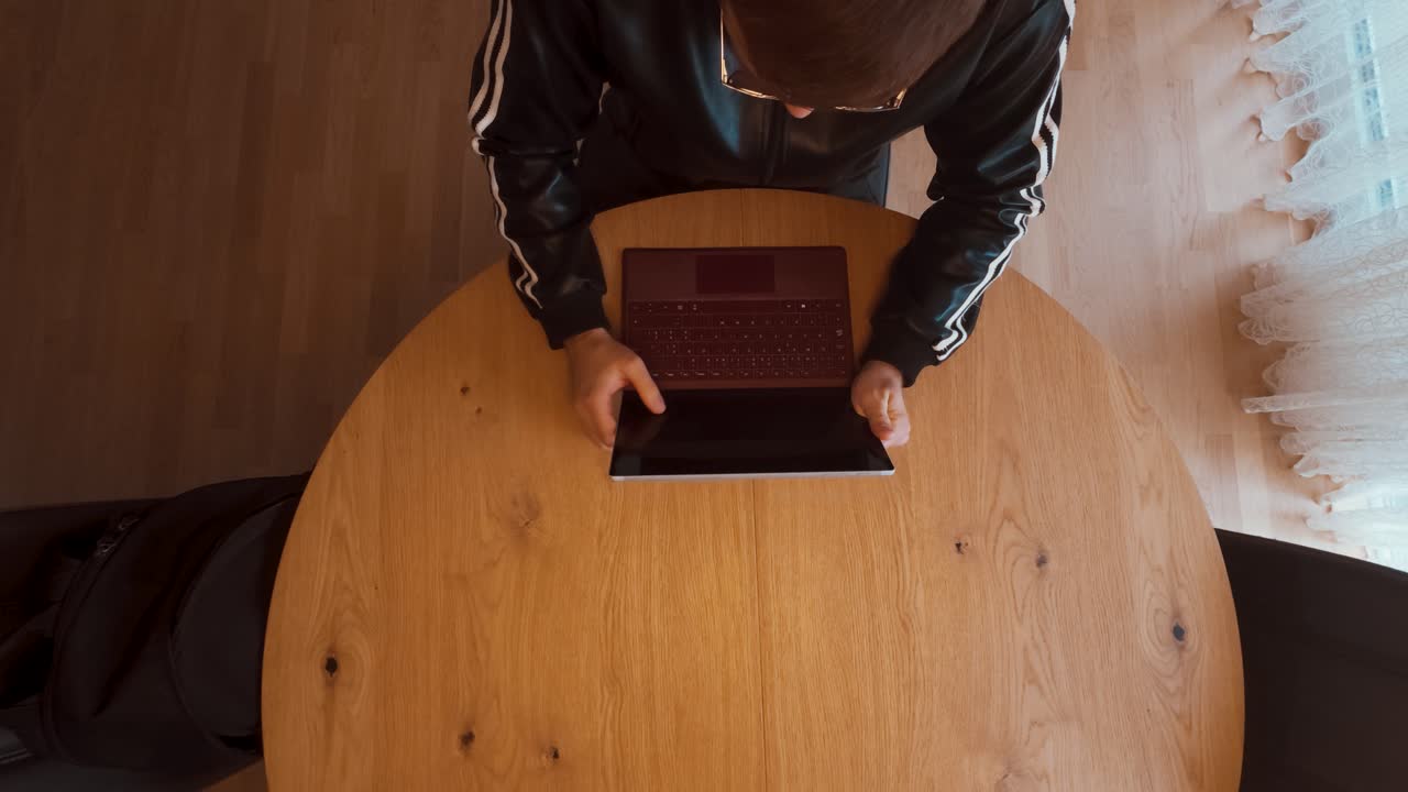 A man quickly unpacks his laptop from a backpack and starts typing nervously. Perfect for business stress, deadlines, remote work, urgency, or productivity concept scenes