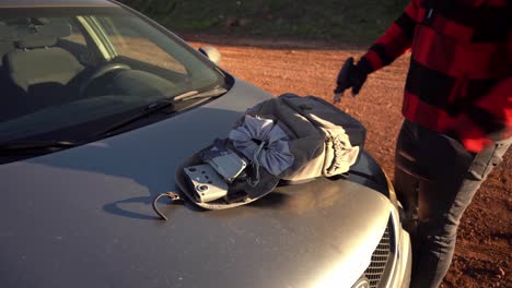 drone pilot unpacking equipment from backpack before flying drone, israel