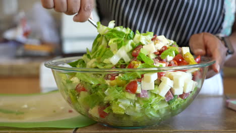 stirring and mixing all the ingredients of a chopped salad - antipasto salad series