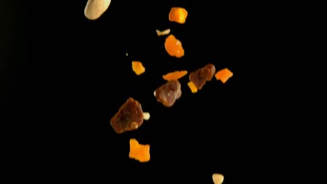 Dry-fruits-falling-against-black-background-4k