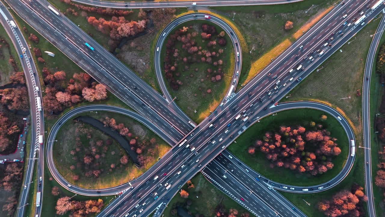 Aerial view of busy freeway interchange in autumn setting