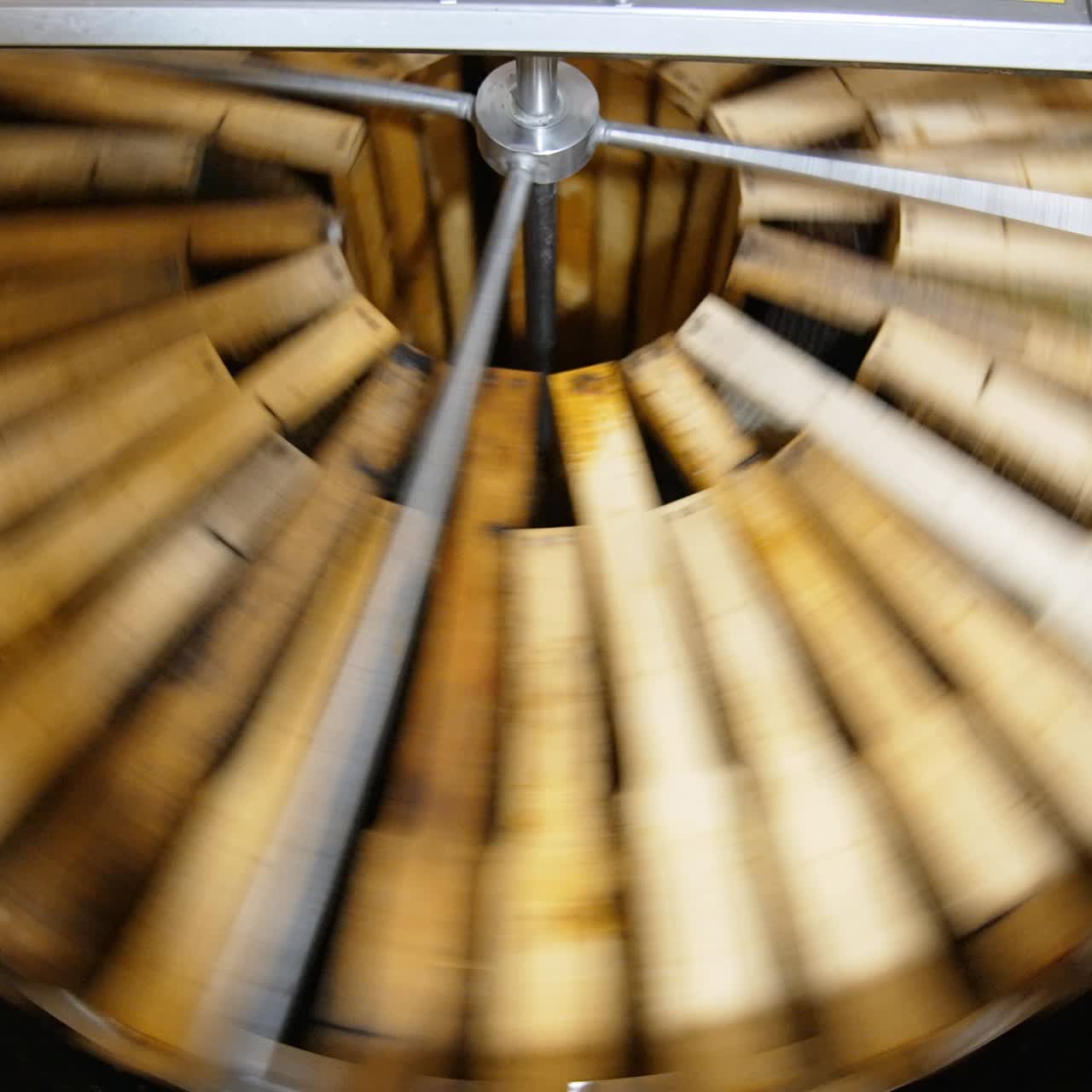 Working honey harvesting apparatus. Honey frames placed in circle are spinning in the centrifuge machine to extract healthy product