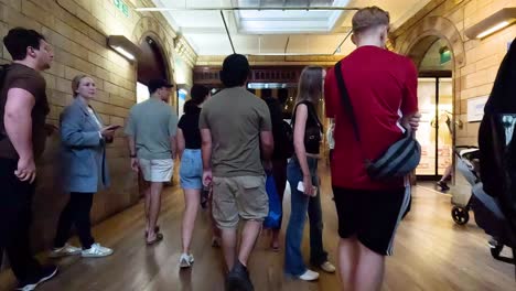 visitors walk through museum's historic corridors