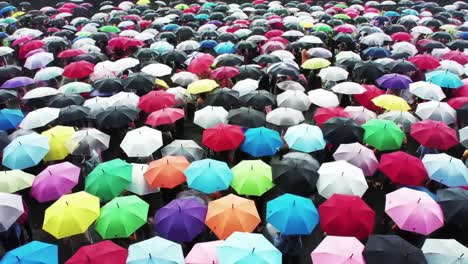 crowd with colorful umbrellas in the rain