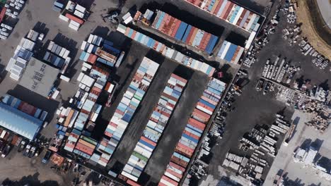 Aerial-above-container-storage-at-industrial-depot-in-Iceland,-circle