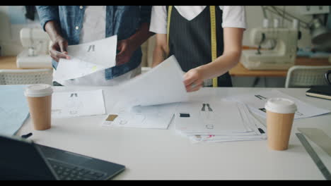 fashion designers reviewing sketches