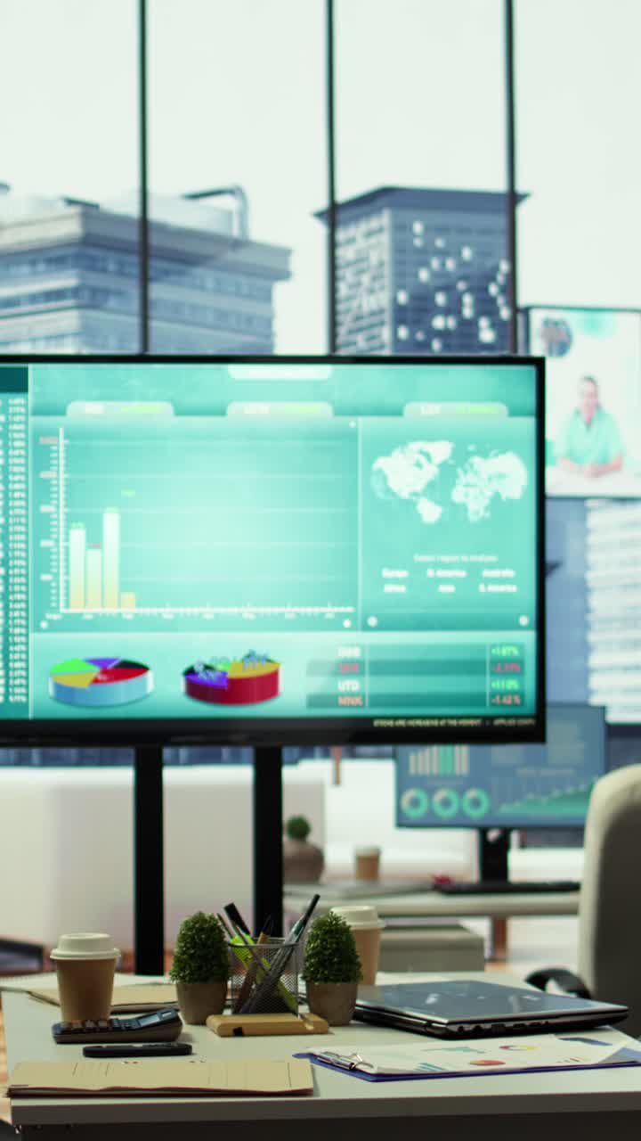 Vertical Video Sleek corporate office with a computer displaying detailed infographics