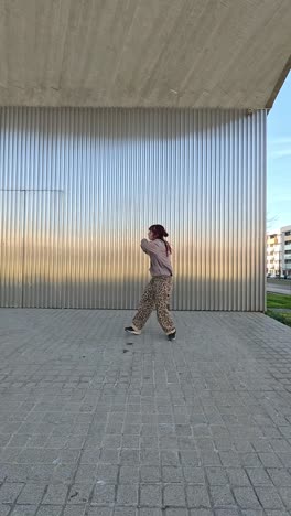 young urban dancer performing modern choreography outdoors