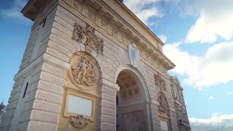 arch of triumph in montpellier in france on a sunny day with colorful blue sky, waving french flag