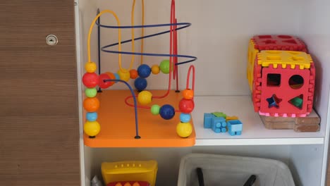 colorful toys stored on shelf in a playroom